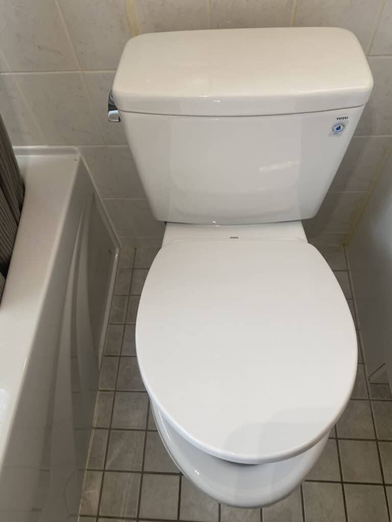 A clean toilet with the seat closing